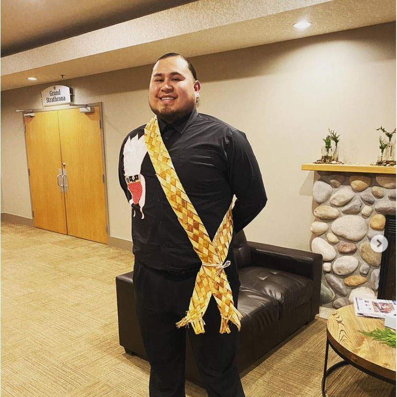 A photo of Terrance Lafromboise smiling and wearing a cedar sash 