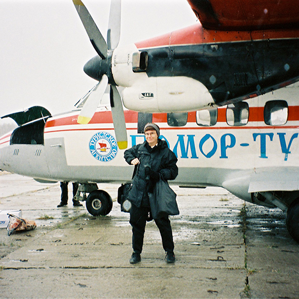 Lynne Viola arriving in Russia with backdrop of a propeller airplane
